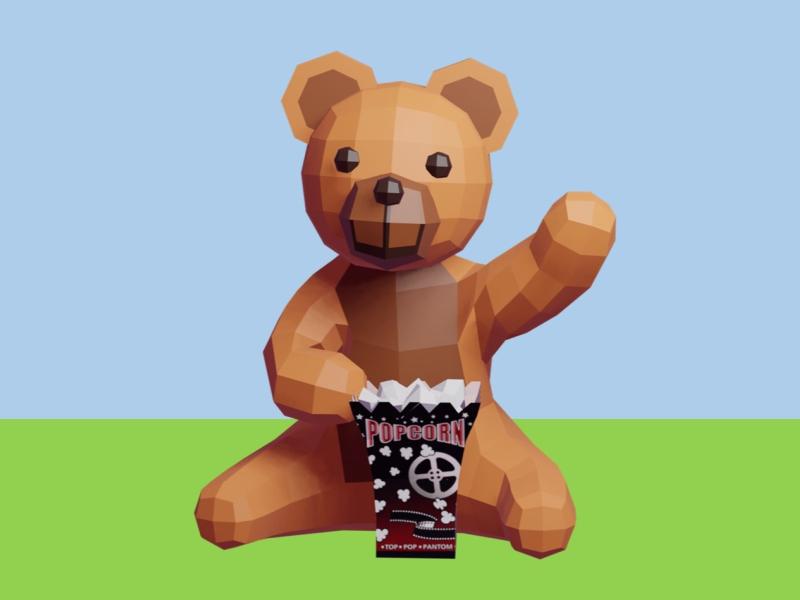 Billede af Bamse, der sidder i det grønne og vinker.